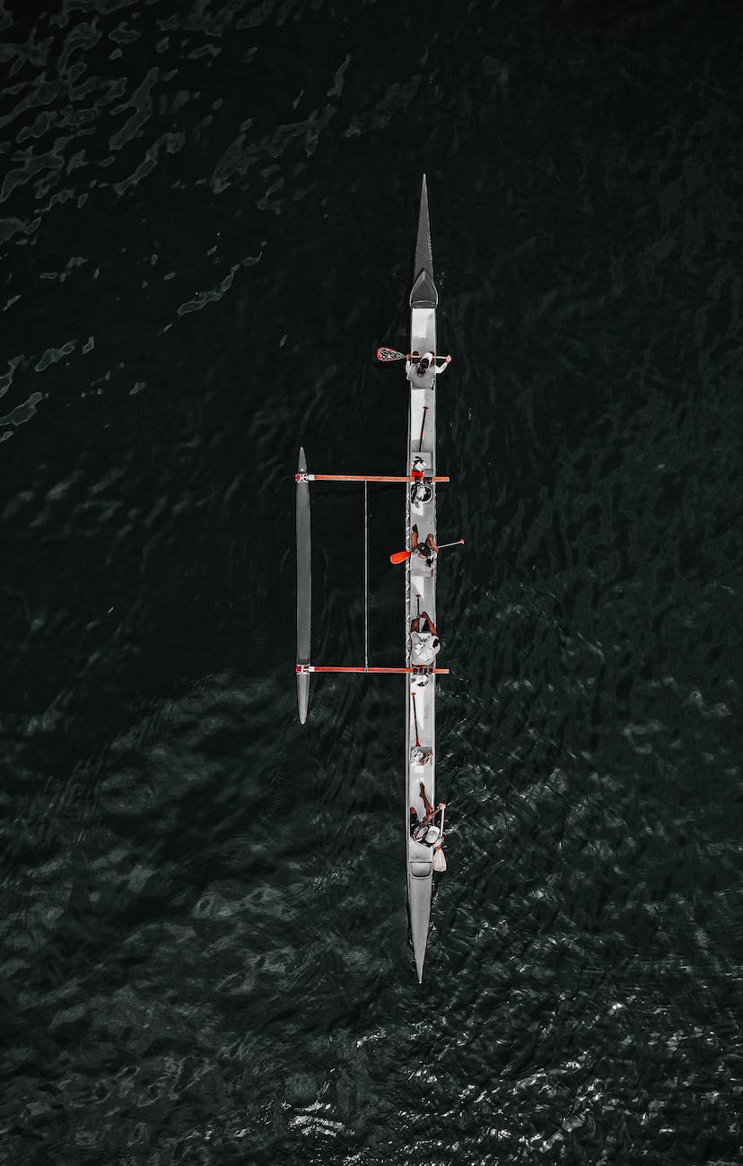 rowing boat with sportspeople in water